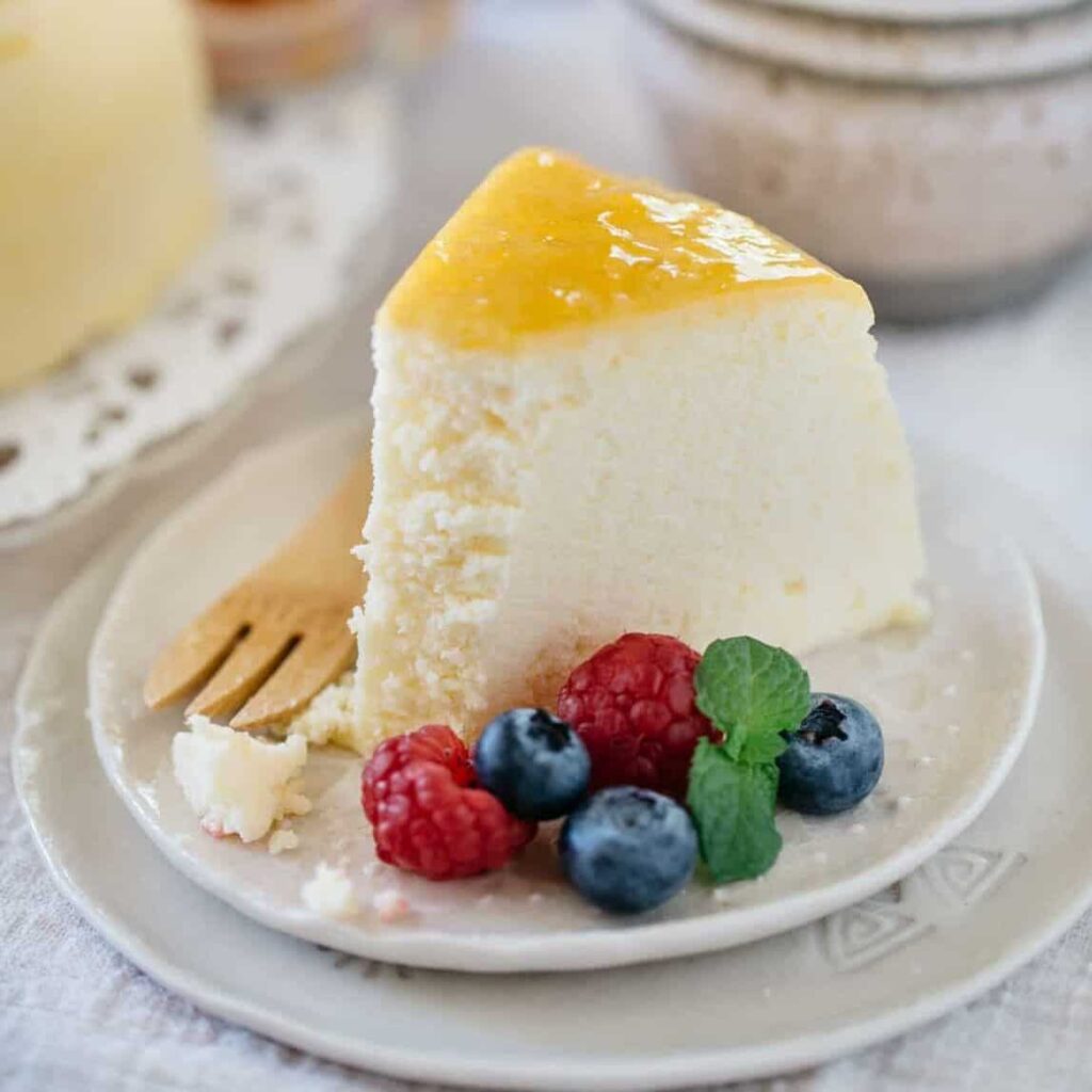 a slice of Japanese cheesecake on a plate with berries