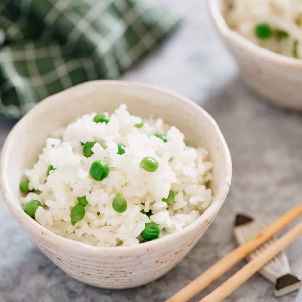 green peas and rice served in a small rice bowl