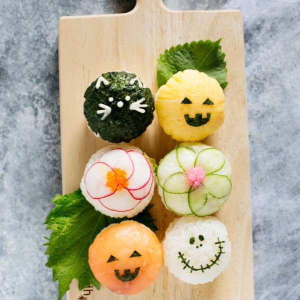 Bird view of Halloween temari sushi on a wooden plate