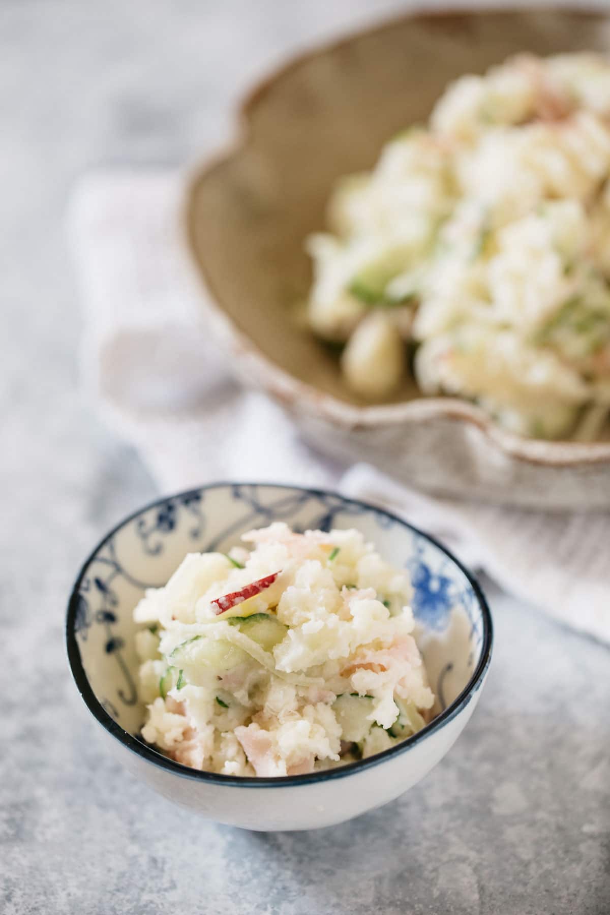 Japanese potato salad served in a big serving bowl and small bowl.