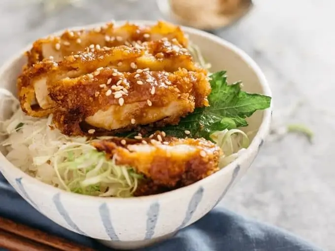 Miso Katsudon served in a Japanese pottery rice bowl with a pair of chopsticks