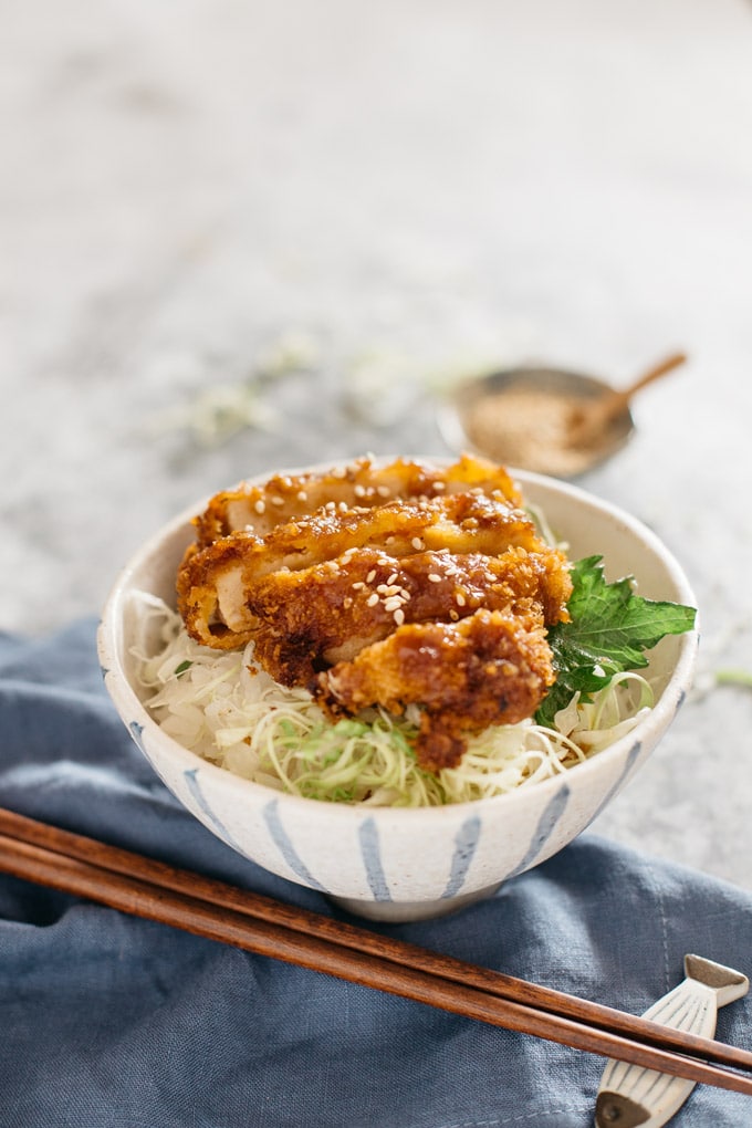 Miso Katsudon served in a large Japanese pottery rice bowl with a pair of chopsticks