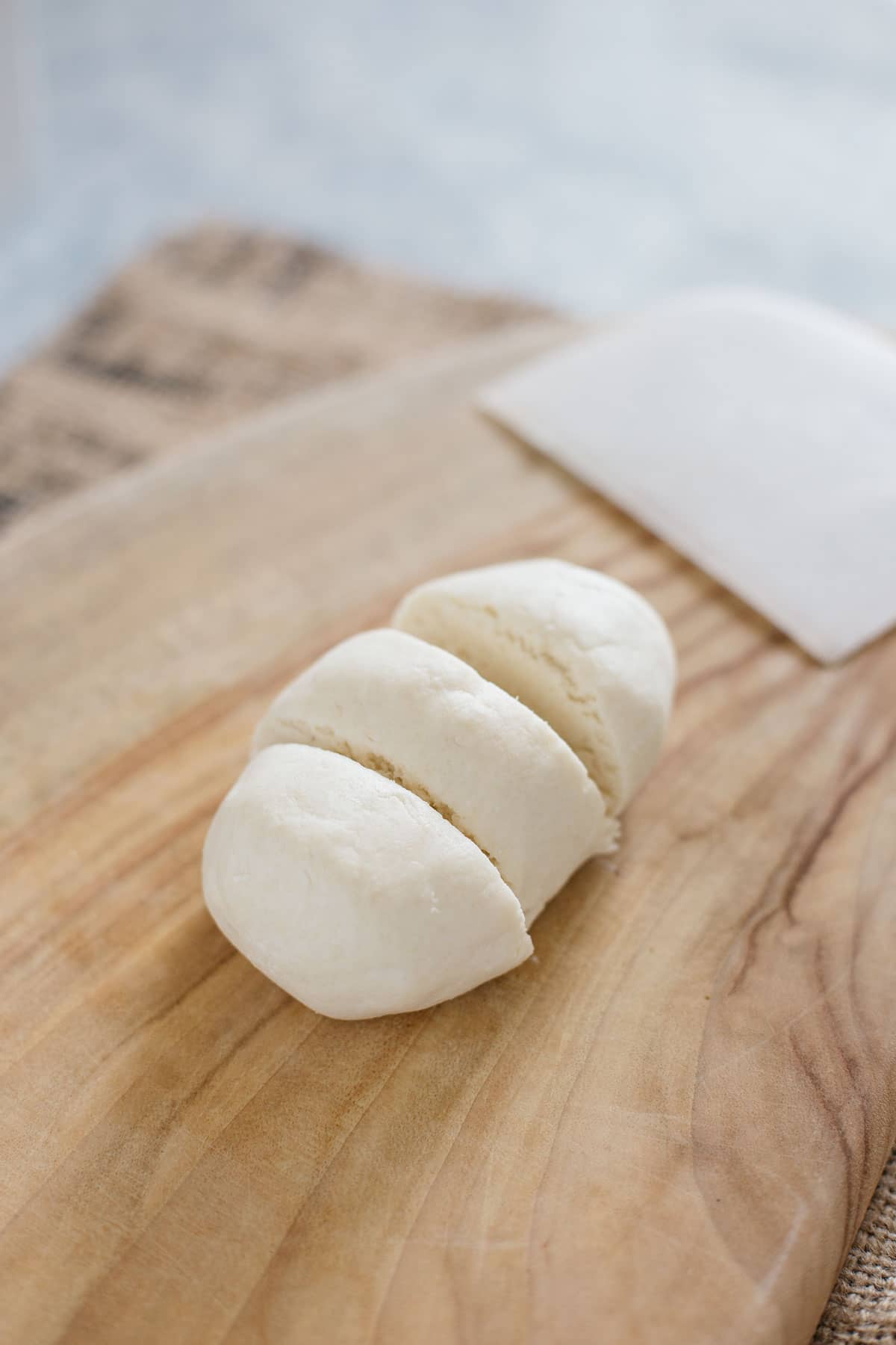 dango dough divided into three on a chopping board