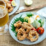 fried calamari served with green salad and mini tomatoes.