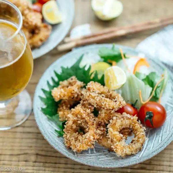 fried calamari served with green salad and mini tomatoes.