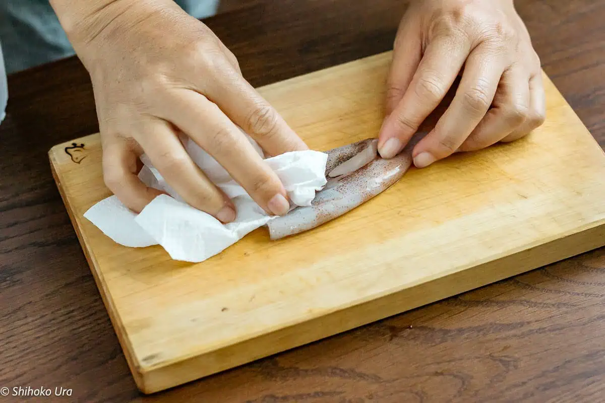 holding the tube with a paper towel and peel off the skin.