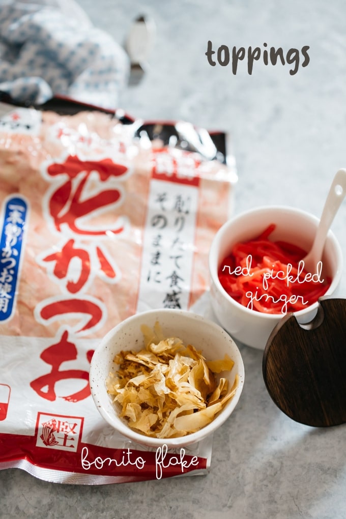 Bonito flake in a packet and also in a small bowl, with red pickled ginger