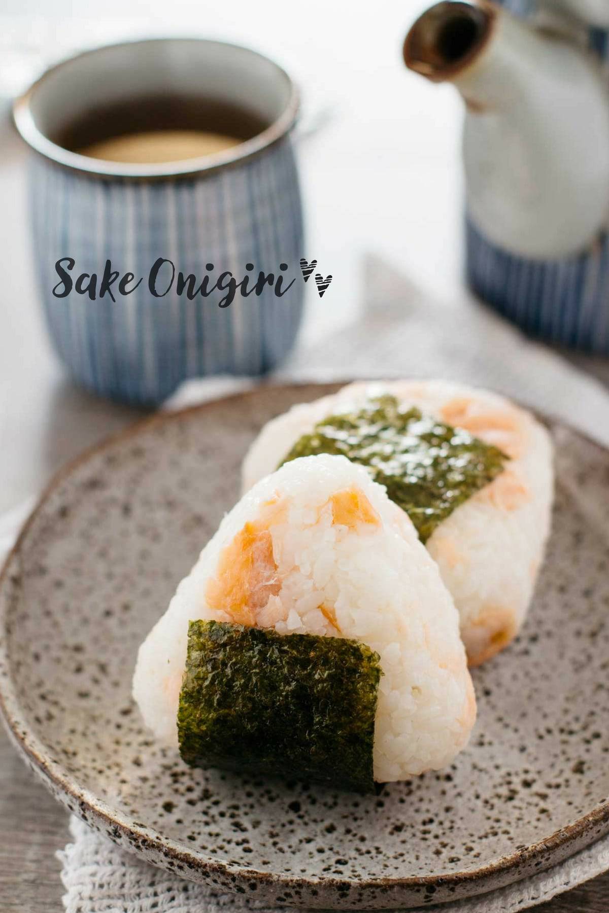 A shot of salmon 'sake' onigiri. Salmon inside rice with a seaweed sheet attached. 