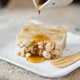 maple syrup poured over invisible apple crumble cake
