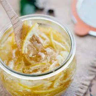 Korean citron tea yuja cha in a jar with a wooden spoon