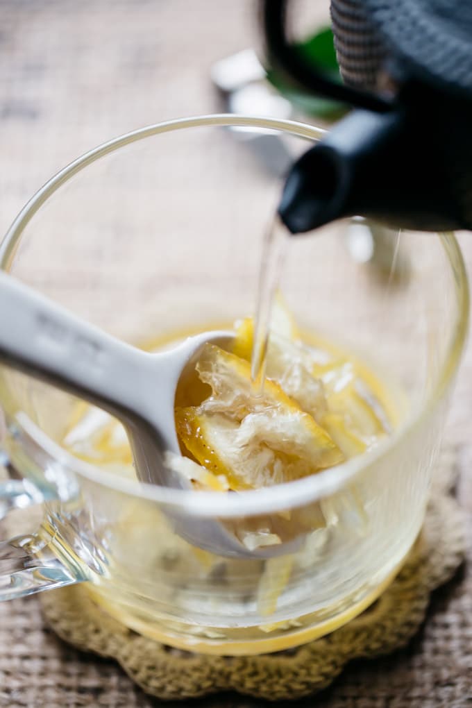 Pouring hot water into a cup with yuzu marmalade in it. 