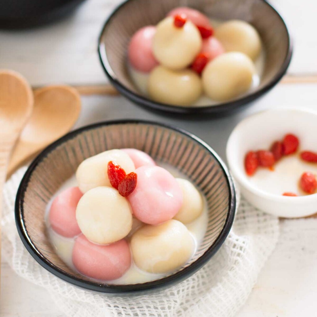pink and white shiratama dango served in a small round bowl