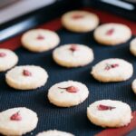 Sablé with sakura cherry blossom flowers just came out of oven and they are still on a oven tray.