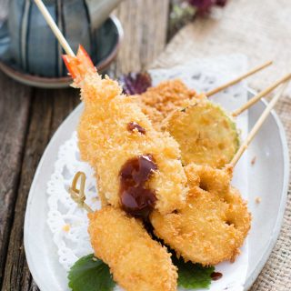 skewered prawn and other ingredients panko crumbed and deep fried on a plate