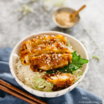 miso katsudon served on a japanese rice bowl with miso sauce drizzling over tonkatsu