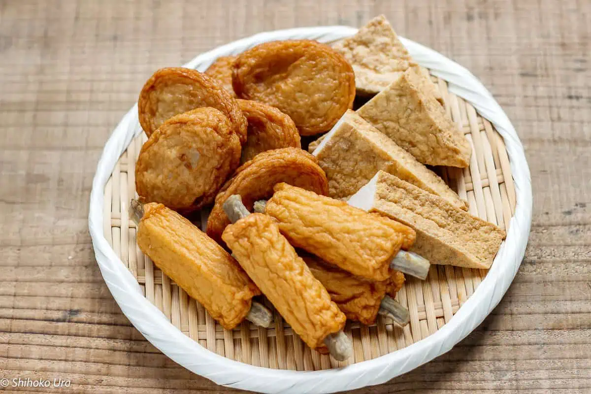 pieces of satsumaage, 4 cut atsuage and 4 pieces of goboten on a round bamboo tray