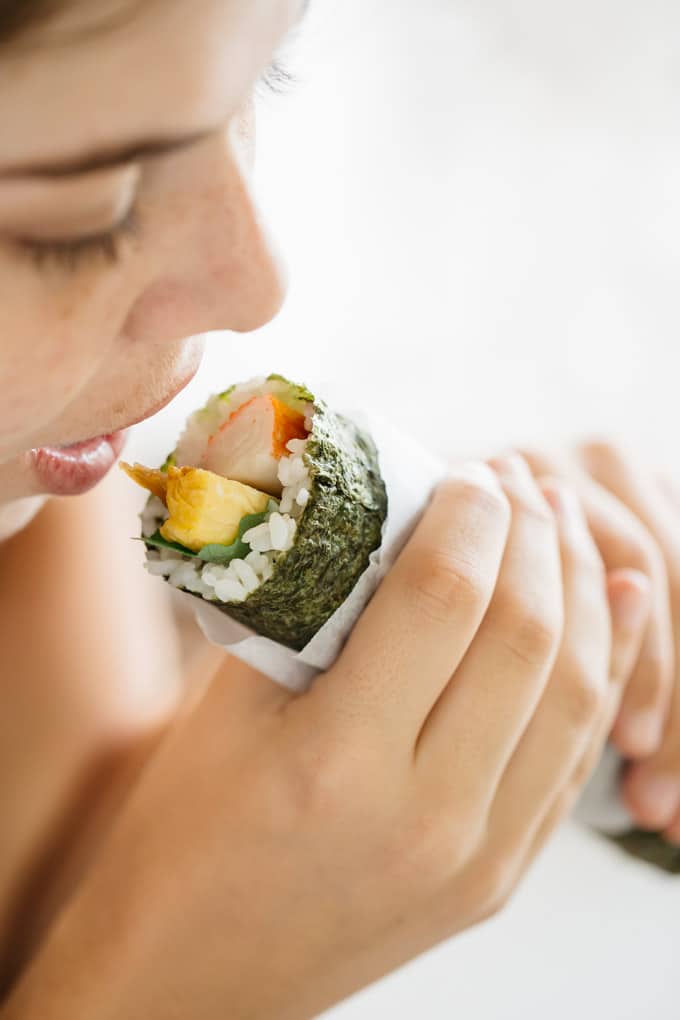 my son's girlfriend trying to eat whole sushi roll