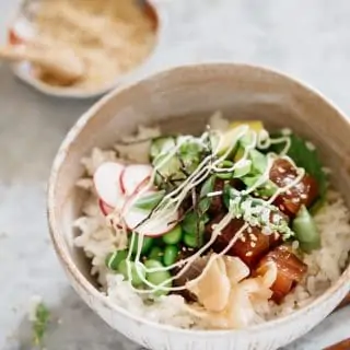 poke bowl dish is served in a Japanese pottery bowl with sesame seeds in a small bowl in background