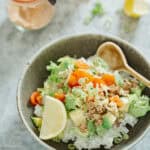 okinawa taco rice served on a shallow bowl with a ceramic spoon