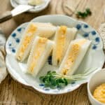 4 pieces of tamago sando served on a plate