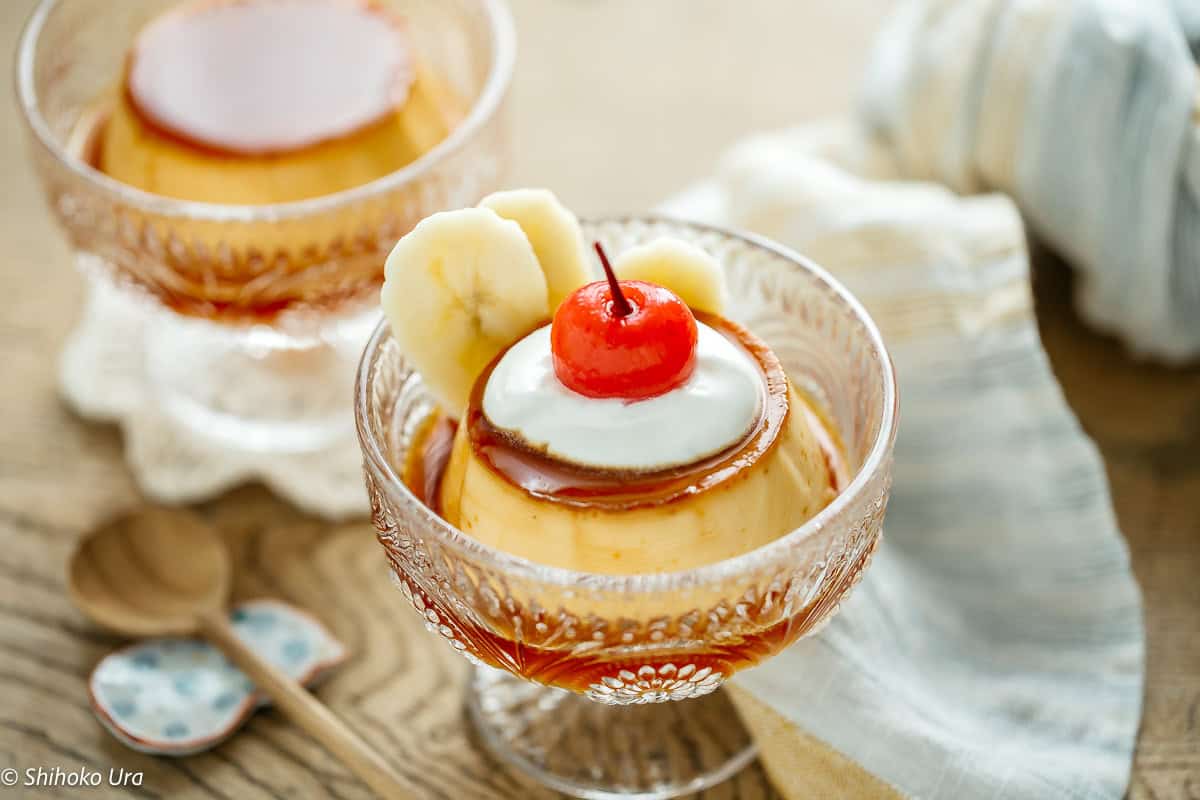 Delicious Japanese custard pudding topped with cherry and banana slices.