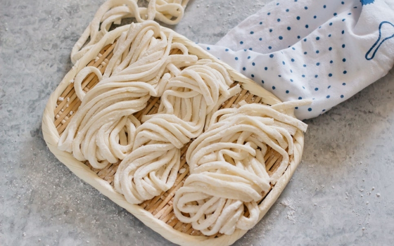 3 portions of Udon noodles on a bamboo tray