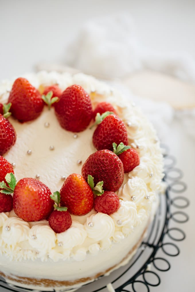 a whole strawberry shortcake cake on cooling wire