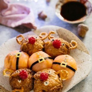 four reindeer rice balls and santa rice balls on a plate