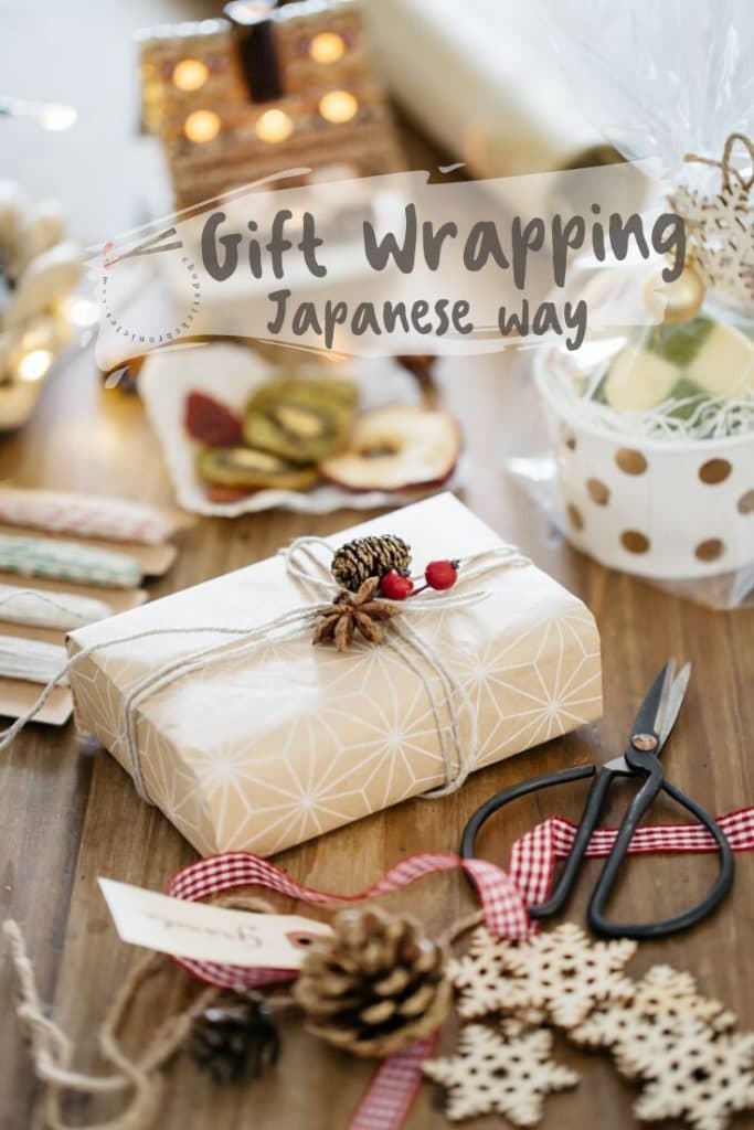 a box neatly wrapped with natural coloured wrapping paper with natural objects and other materials need for wrapping around it.