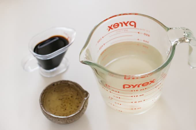 Dashi stock in a jug, soy sauce and mirin in small bowls