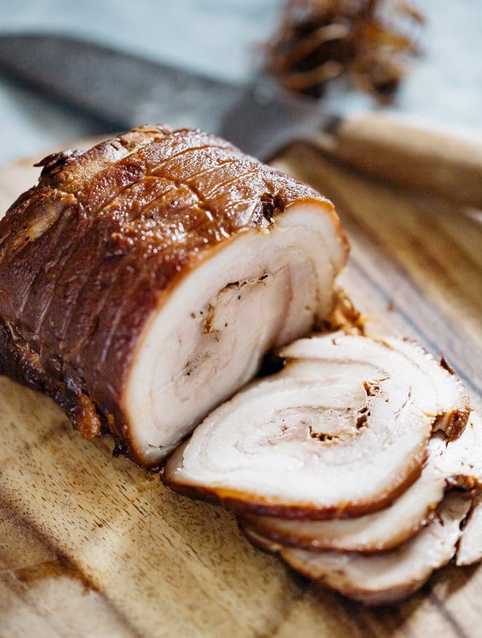 Chashu being sliced on a chopping board