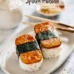 Two Spam musubi served on an oval plate with a pair of chopstick #spammusubi