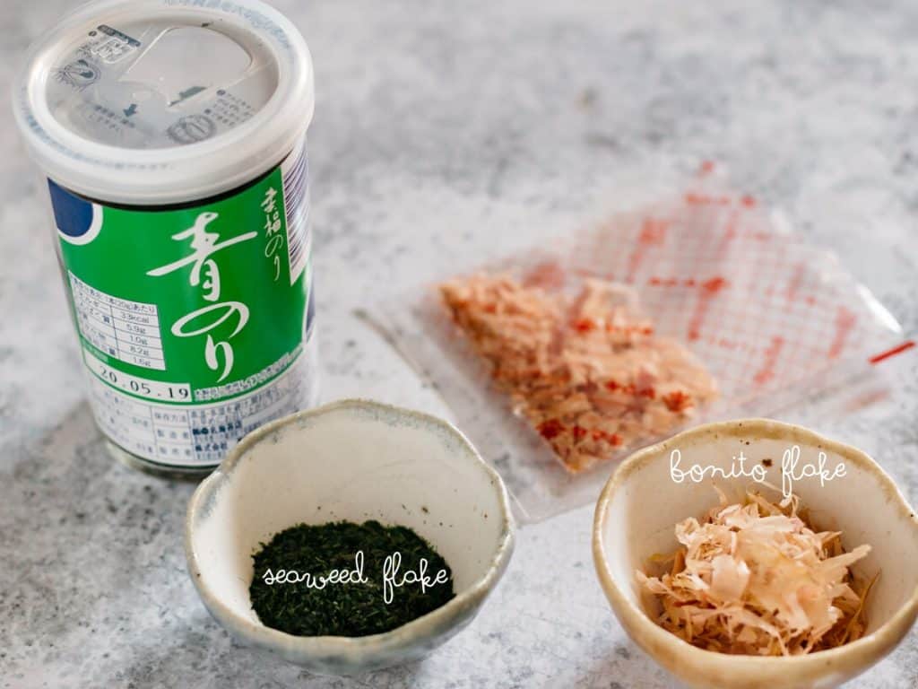 seaweed flake in a jar and also in a small bowl and a small bowl of bonito flake