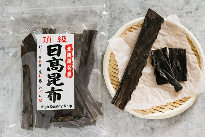 Hidaka konbu in a packet on the left and konbu on a bamboo tray on the right