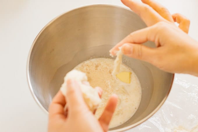 Adding yudane to a bowl of other Japanese bread ingredients