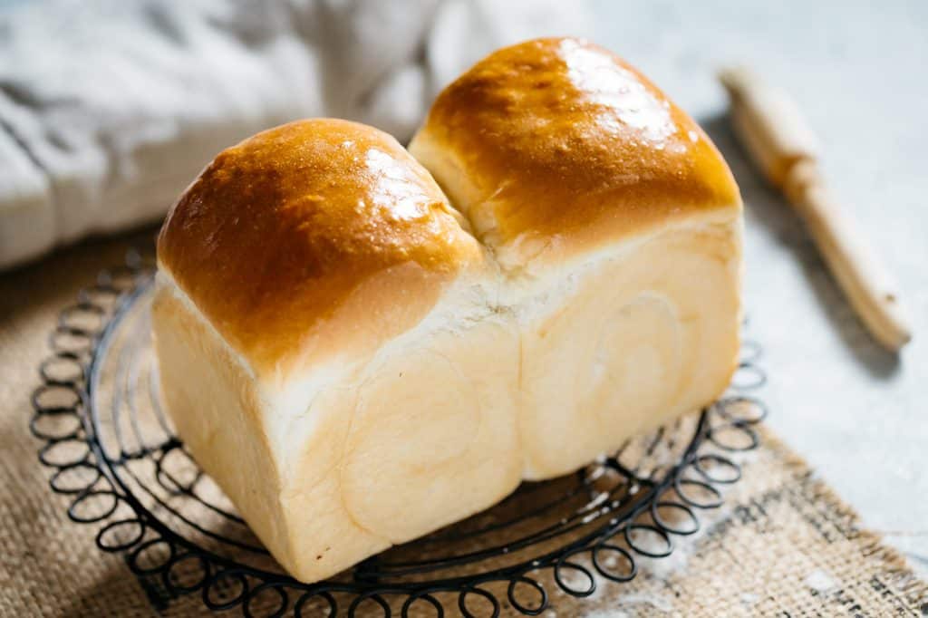 Freshly baked Shokupan Japanese milk bread on a cooling wire rack
