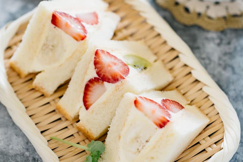 3 pieces of fruit sandwiches on a bamboo tray 