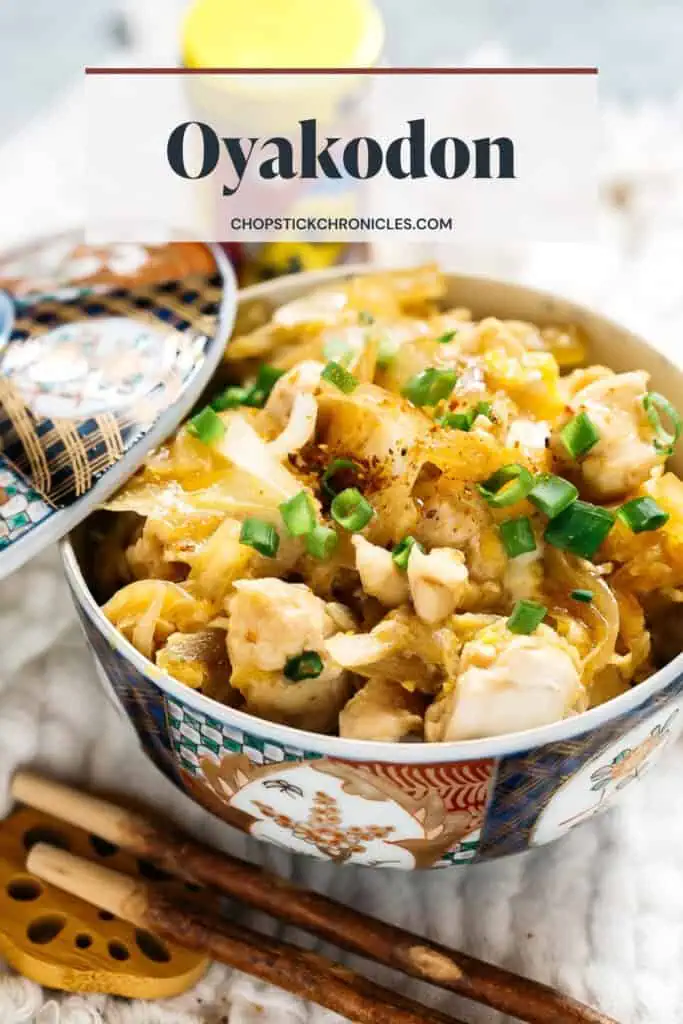oyako don served in a donburi bowl with a lid with text overlay for pinterest