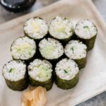 9 hosomaki pieces served on a plate with sushi ginger