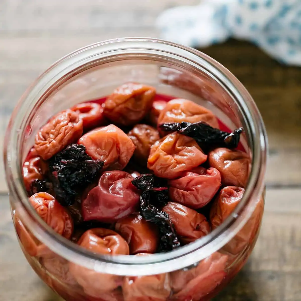 Pickled umeboshi plums in a glass preserve jar