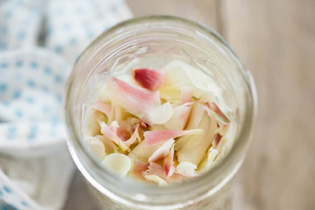 pickled ginger cooked and placed in a preserving jar