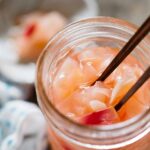 pickled ginger in preserving jar with a pair of chopsticks