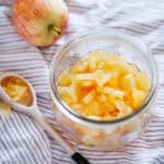 Japanese apple jam preserved in a jar with a ceramic spoon and an apple in background