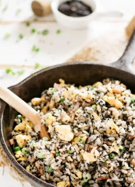 Black sesame fried rice cooked in a cast iron frying pan