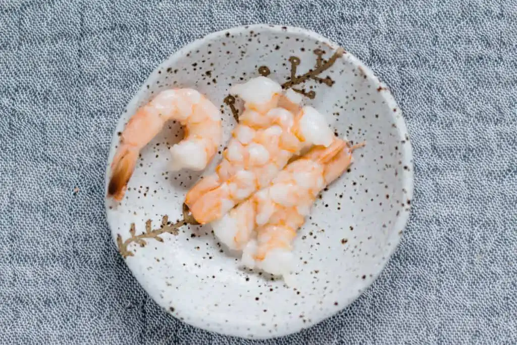 cooked and peeled prawn on a small plate