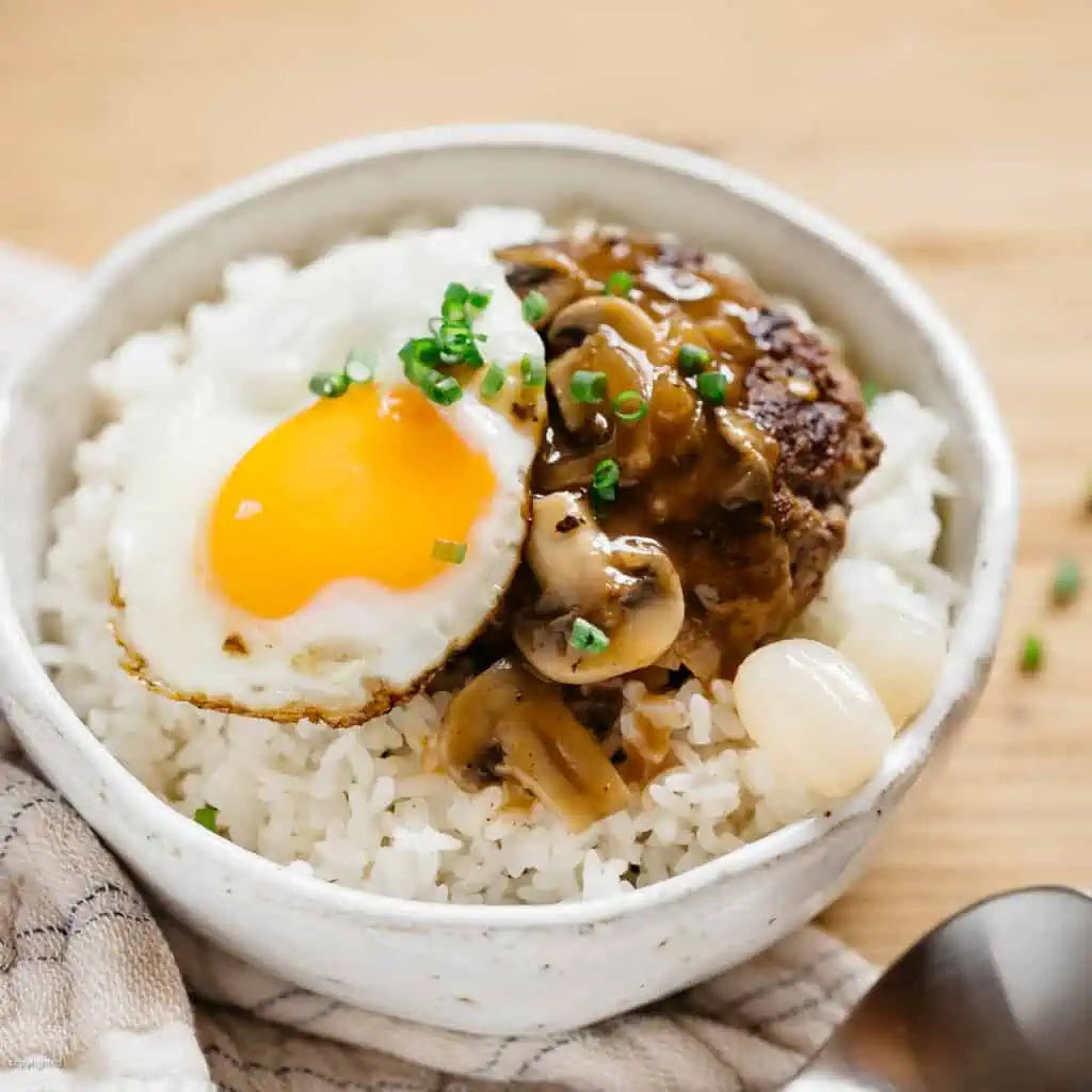 loco moco served in a rice bowl with a spoon