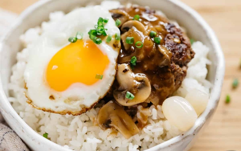 loco moco served in a rice bowl with a spoon