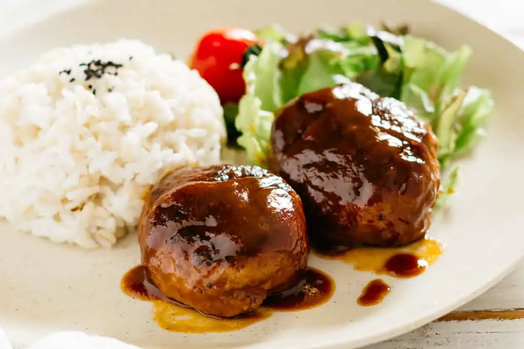 yoshoku Japanese hamburger served on a plate with rice and salad