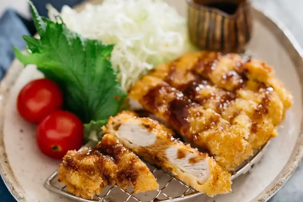 Tonkatsu served on a plate with shredded cabbage