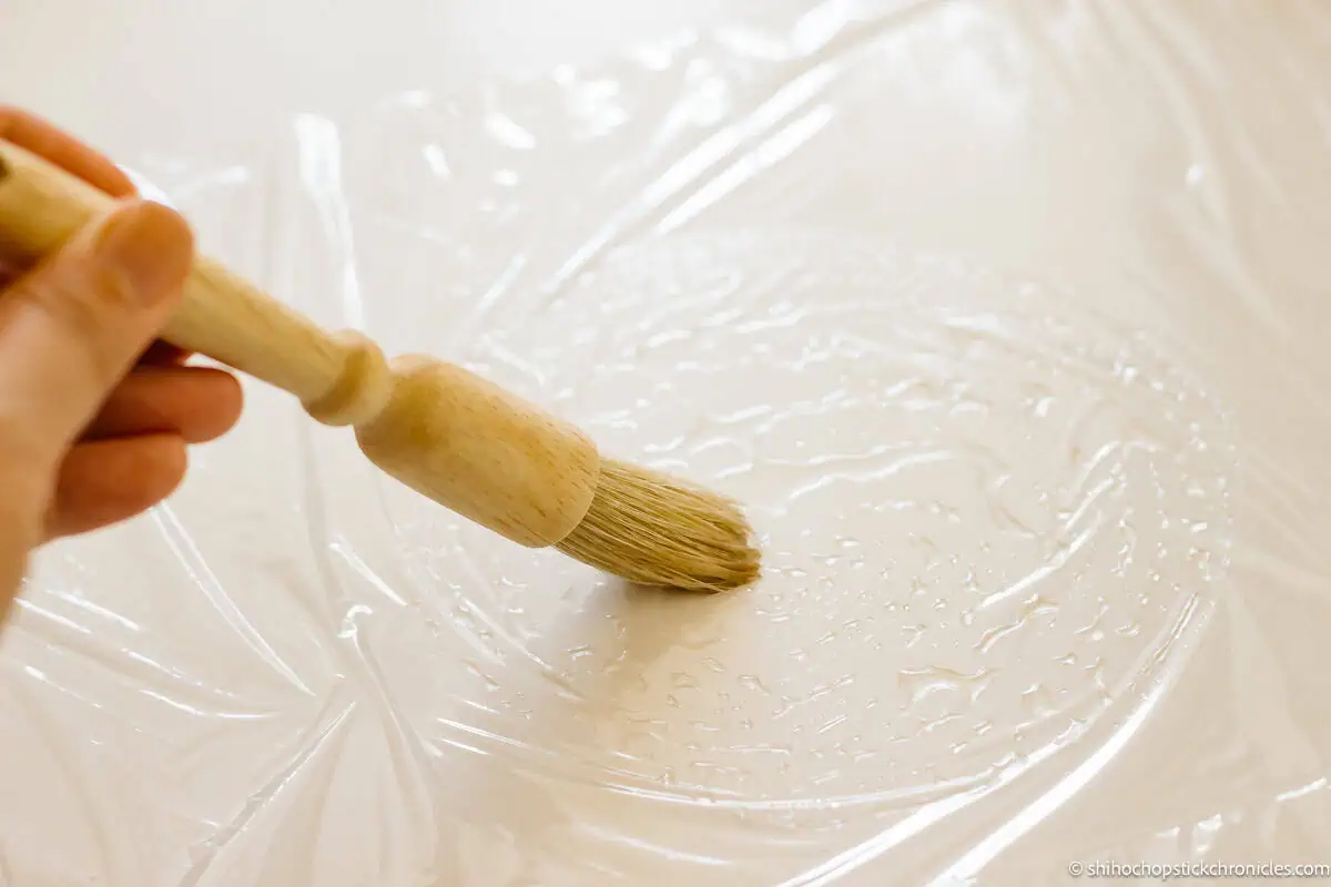 sweet syrup is being spread with a brush